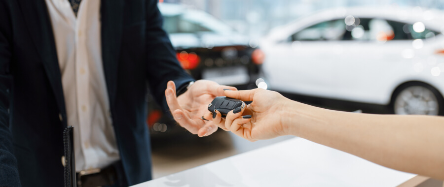 Two people sharing car keys