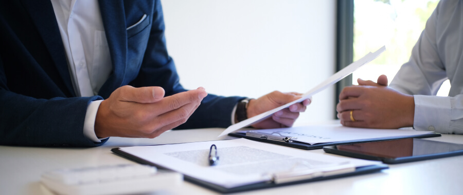 Insurance agent with client looking at papers