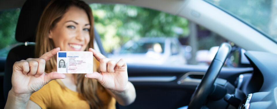 woman holding up driver's license