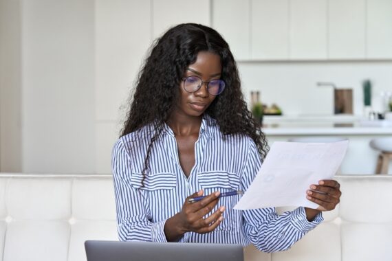 woman on laptop filling out paperwork