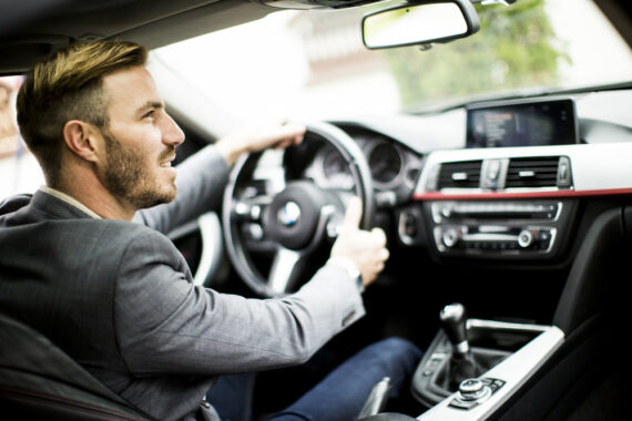 Young man driving in the modern car