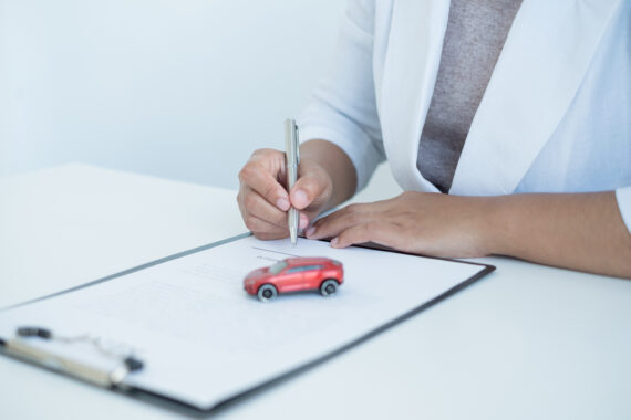 person with document on clipboard and car toy