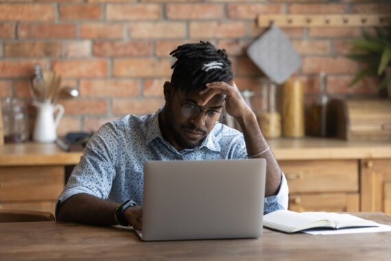 unhappy man on computer