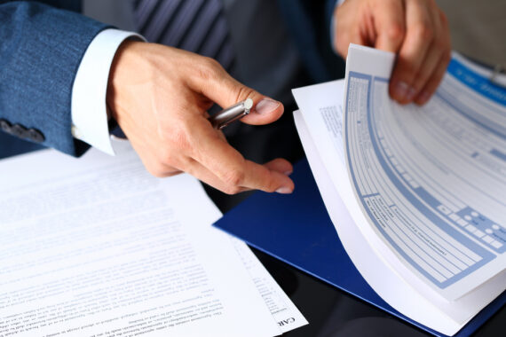 man going through insurance form paperwork