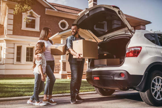 couple unloading car moving to new home