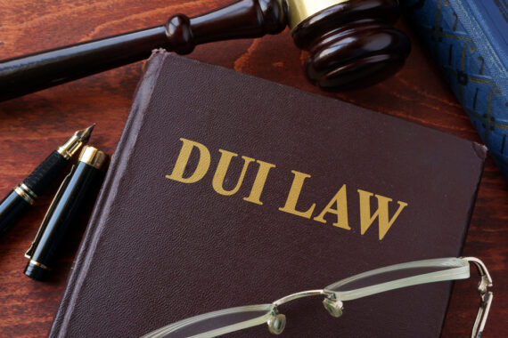 DUI law book on table with gavel and glasses