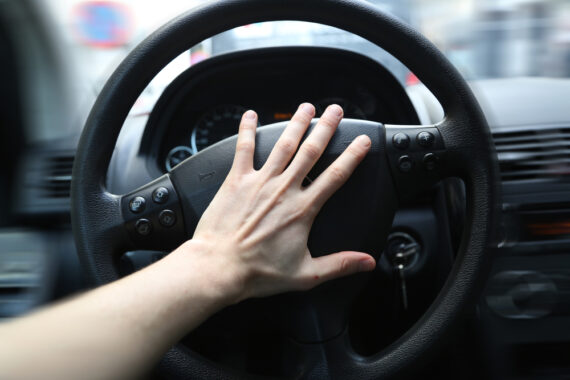 Hand honking a car