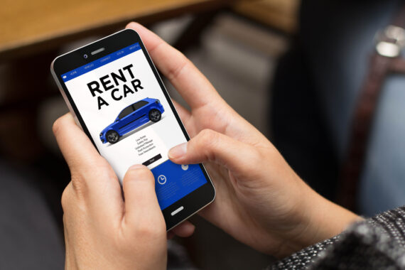 Hands holding a cell phone searching for car rental - renting a car with SR-22 insurance